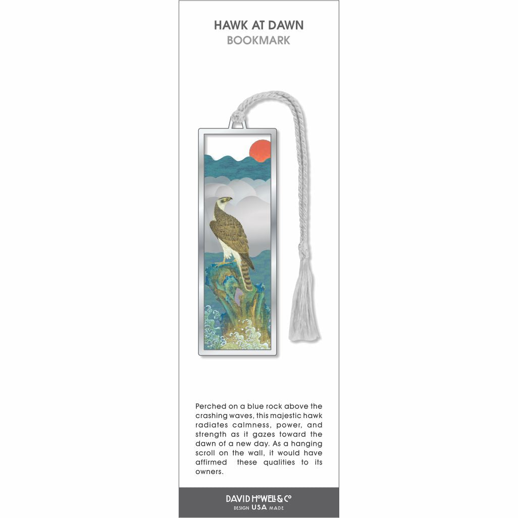 Hawk at Dawn bookmark, a poised hawk perched on a rocky outcrop above waves with a rising sun, finished with a soft gray tassel.