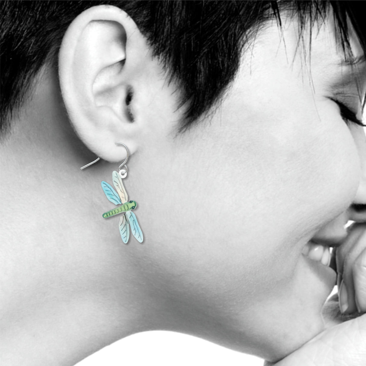 Dragonfly earrings: green and blue dragonfly drop earring worn on ear.