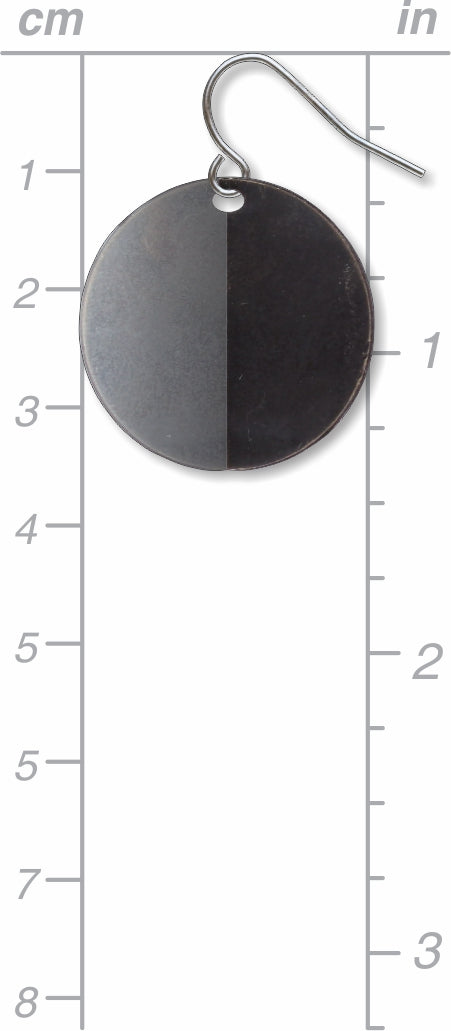 An Orb circular drop earring with a split-tone black and gray finish, shown with size scale for reference and inspired by Ellsworth Kelly’s minimalist sculptural forms