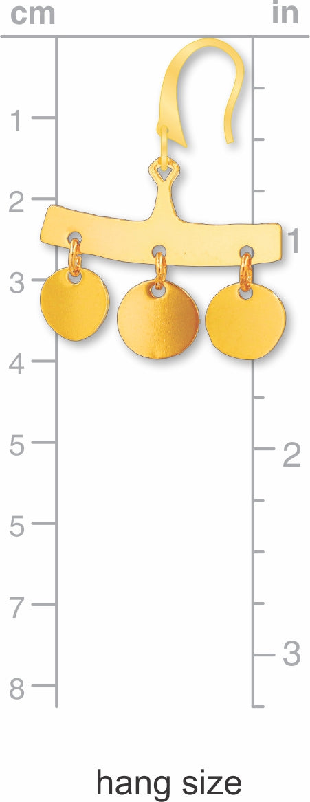 Gold earring on a measurement chart with centimeter and inch scales.