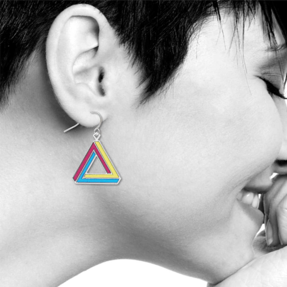 Deception earrings: pink, yellow, and blue impossible triangle drop earring worn on model.
