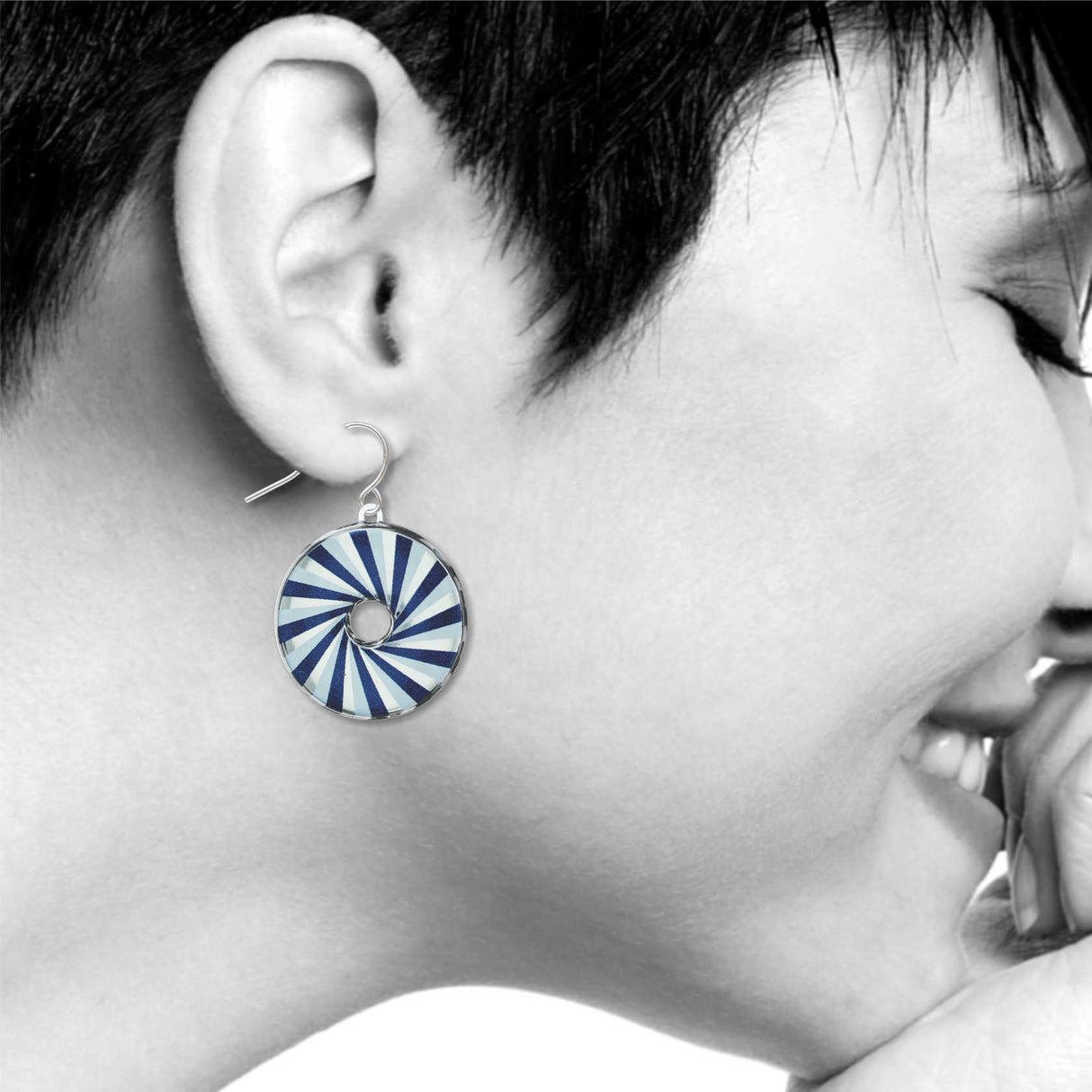 Belmont Blue earrings: navy blue, light blue, and white spiral circle drop earring on model