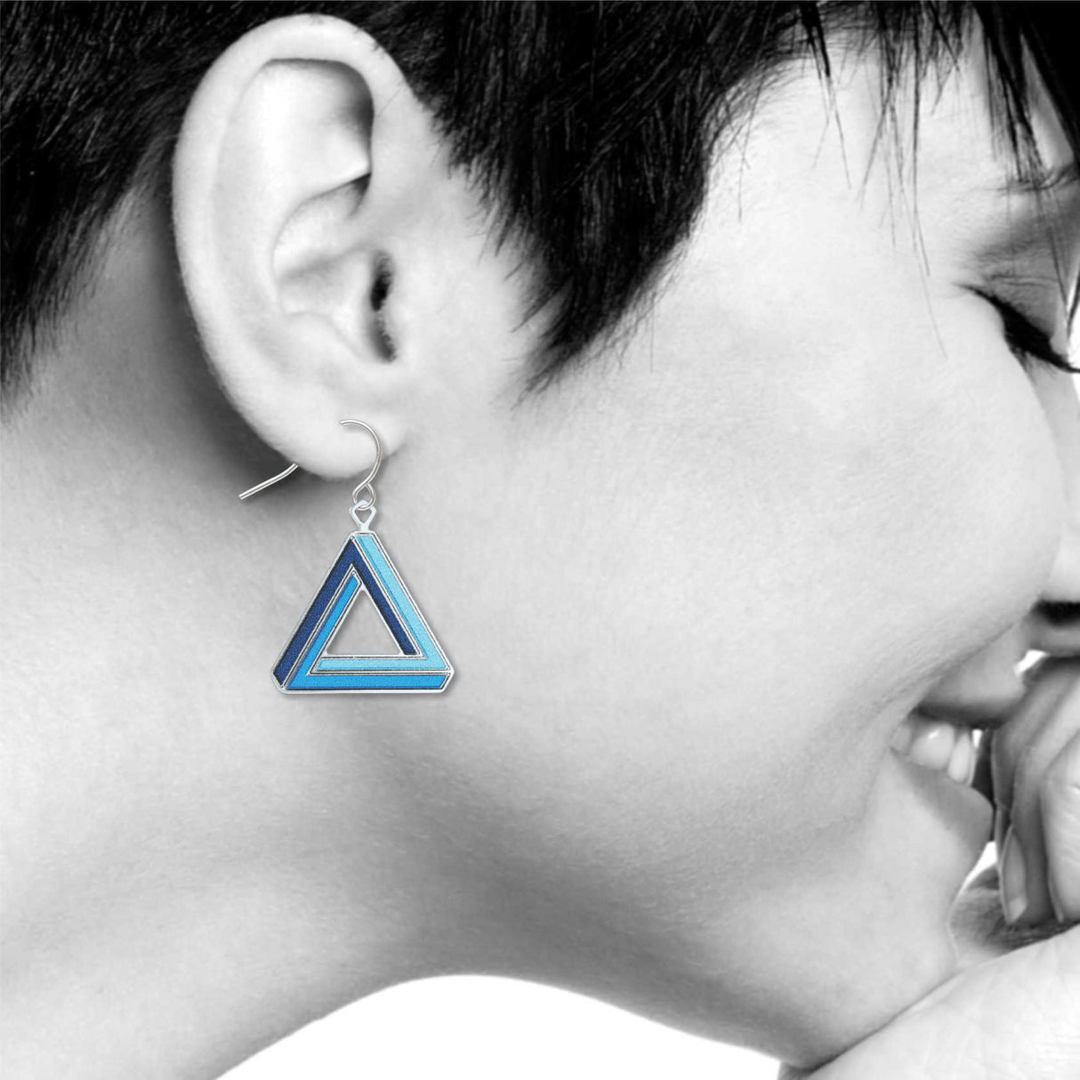 Illusion earrings: navy blue, blue, and light blue impossible triangle drop earring inspired by optical illusions on a model