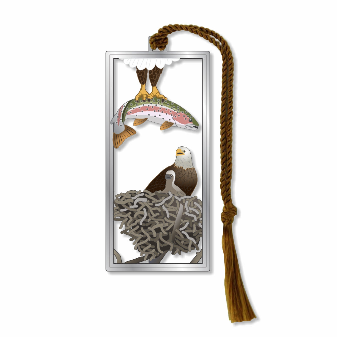 A metal bookmark featuring an illustration of an eagle with a fish in its beak, and a nest with eaglet in the background, attached to a brown braided tassel for a museum-quality gift for animal and nature lovers, national park goers, bird watchers and readers.