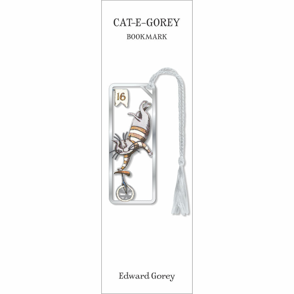 A book bookmark card for 'CAT-E-GOREY' featuring an illustration of a cat on a unicycle in silver and gold tones, with a white tassel, and the name Edward Gorey printed at the bottom.