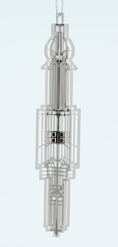 Decorative silver metal Frank Lloyd Wright Chauncey Williams Keepsake with a complex geometric design.