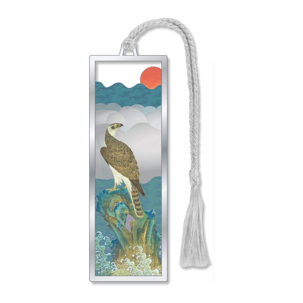 Hawk At Dawn metal bookmark featuring a majestic hawk perched on a blue rock above crashing waves, warm sunrise tones in background, symbolizing calmness, power, strength, and the promise of a new day with gray tassel for a booklover gift.