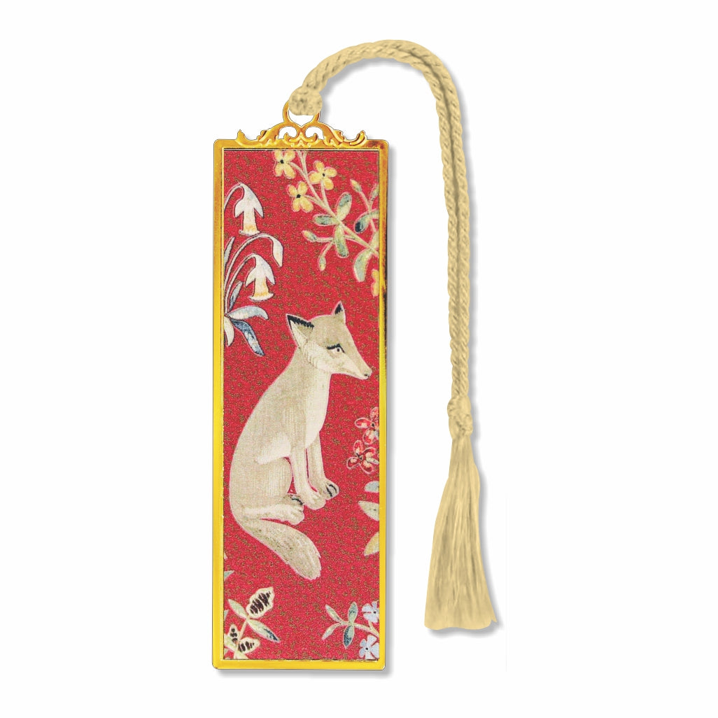 A metal bookmark with a medieval design featuring a fox, surrounded by floral patterns, with a gold-colored border and cream tassel.