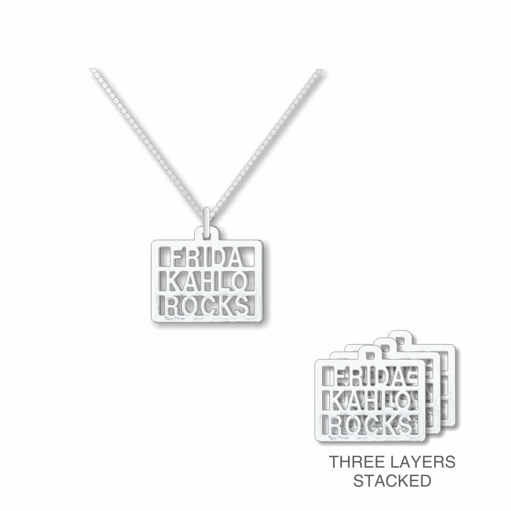 Silver necklace with 'Frida Kahlo Rocks' pendant on a white background