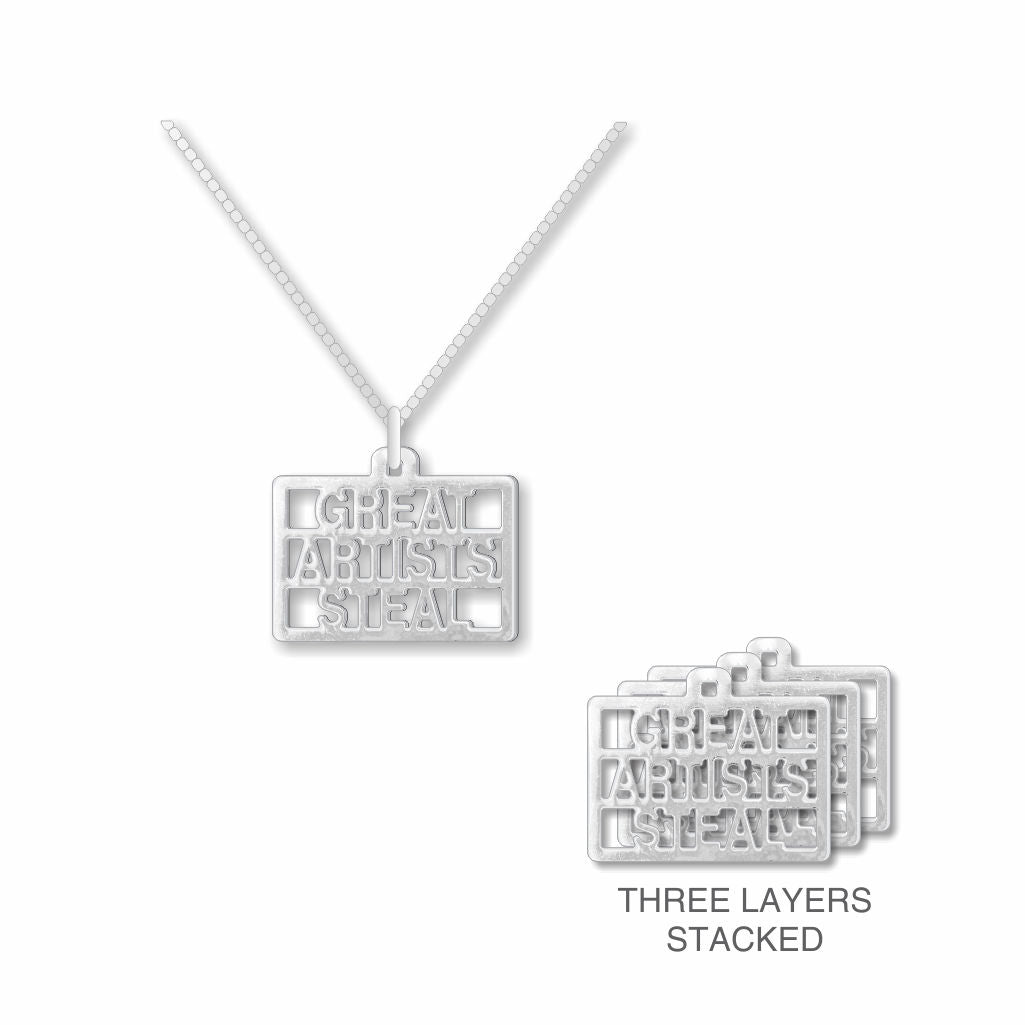 Great Artists Steal necklace with a silver cutout text pendant on a chain, shown alongside a side view highlighting the pendant’s three-layer stacked construction.