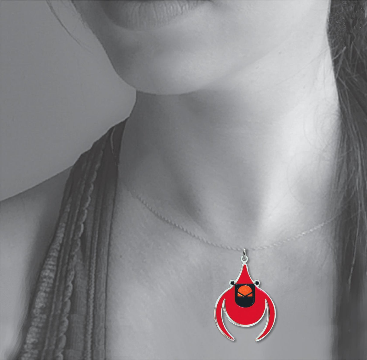 Model wearing the Cardinal pendant necklace featuring a vibrant red stylized bird charm inspired by Charley Harper’s minimalist nature artwork.