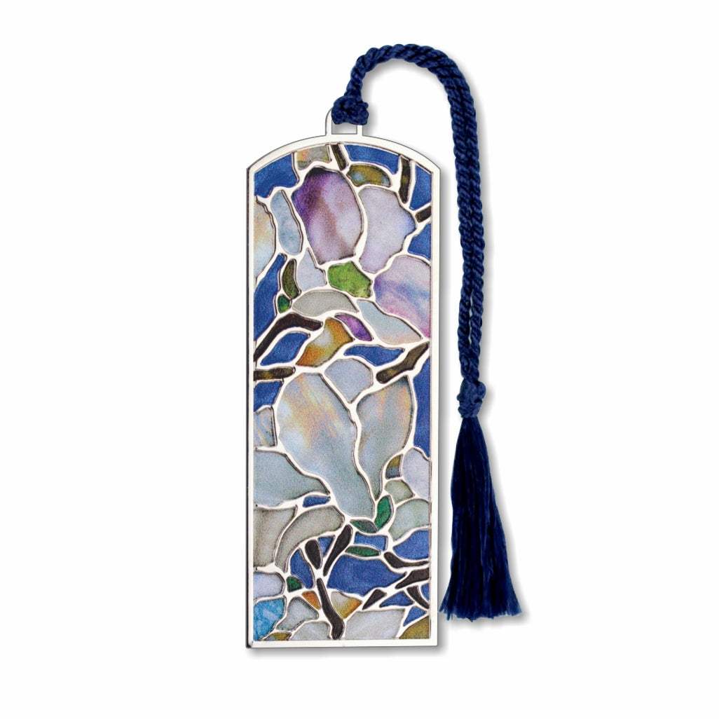 A silver metal Tiffany bookmark with a floral pattern, featuring a magnolia flower design, in shades of blue and white, with a blue tassel.