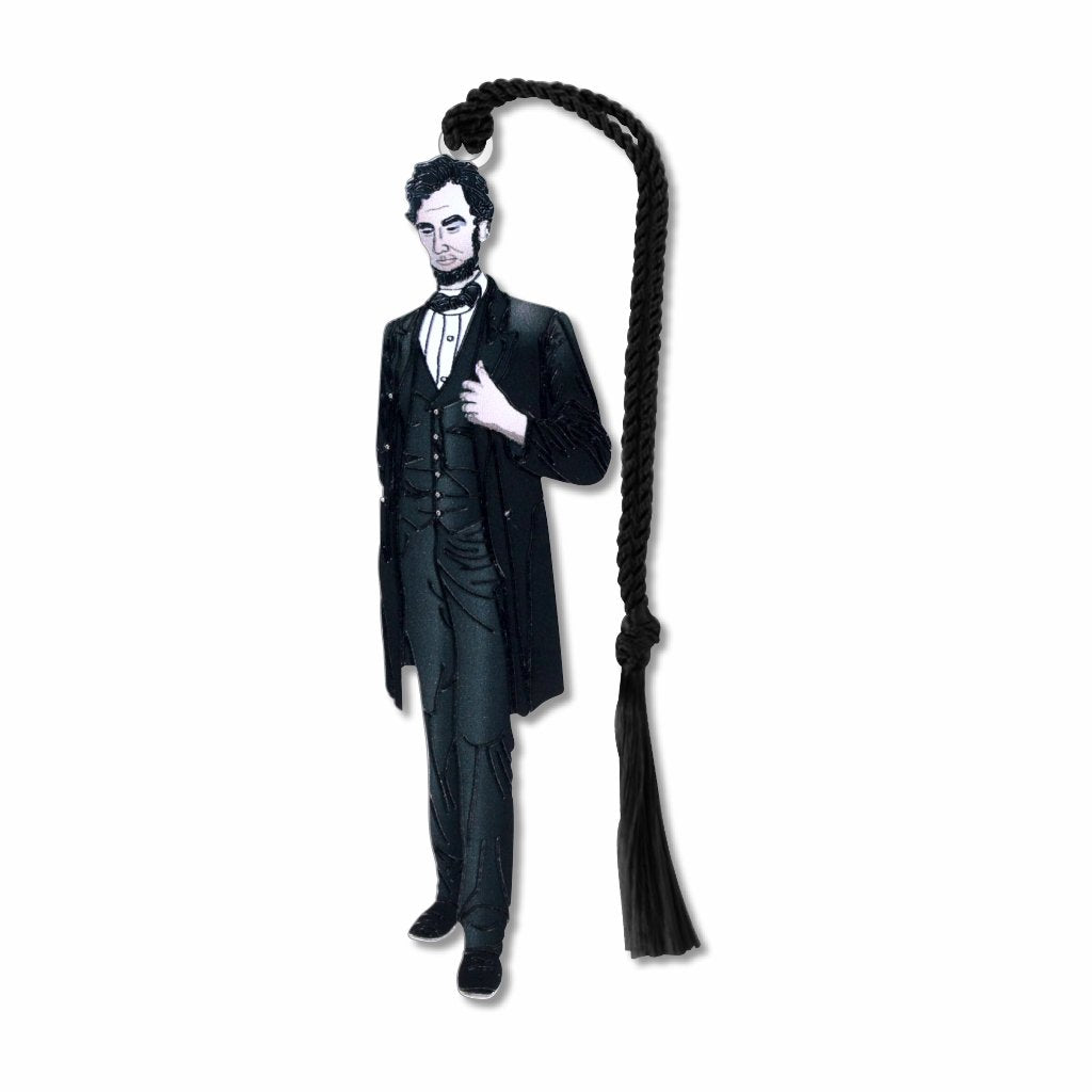 A metal bookmark shaped like Abraham Lincoln with a black tassel, featuring an illustration of Lincoln in his presidential attire.