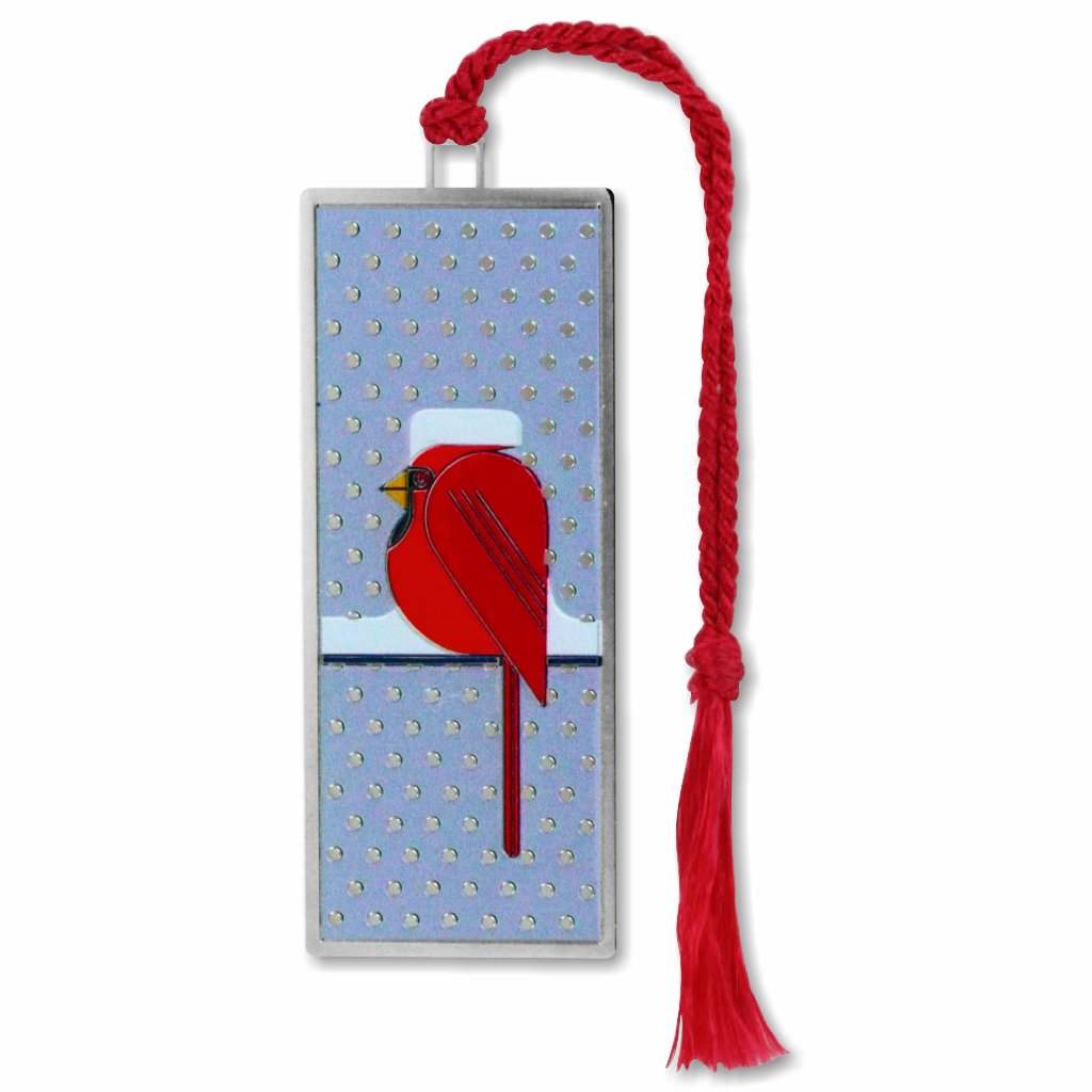 A metal bookmark with a red cardinal bird design with snow on his head attached to a red tassel.