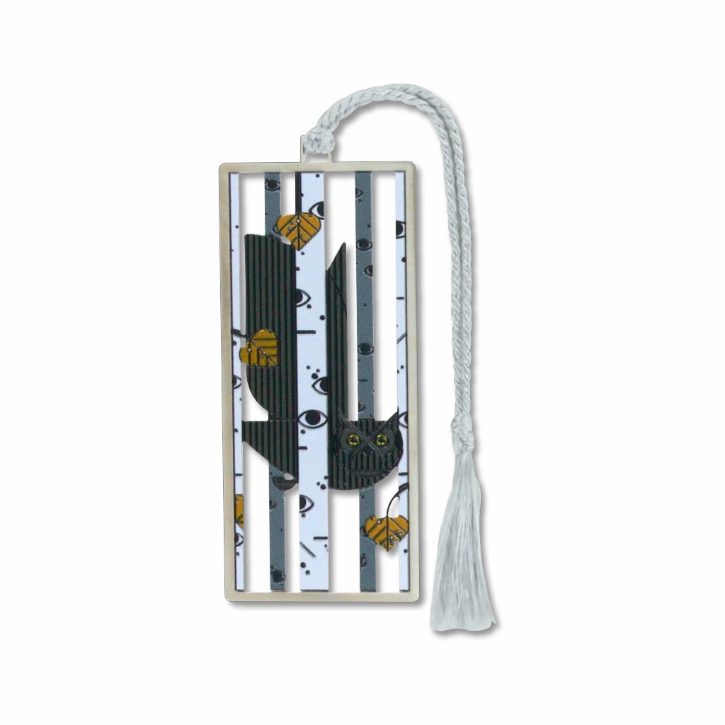 A silver metal Charlie Harper bookmark with a silver finish featuring an artistic depiction of an owl perched on branches, connected to a white tassel.