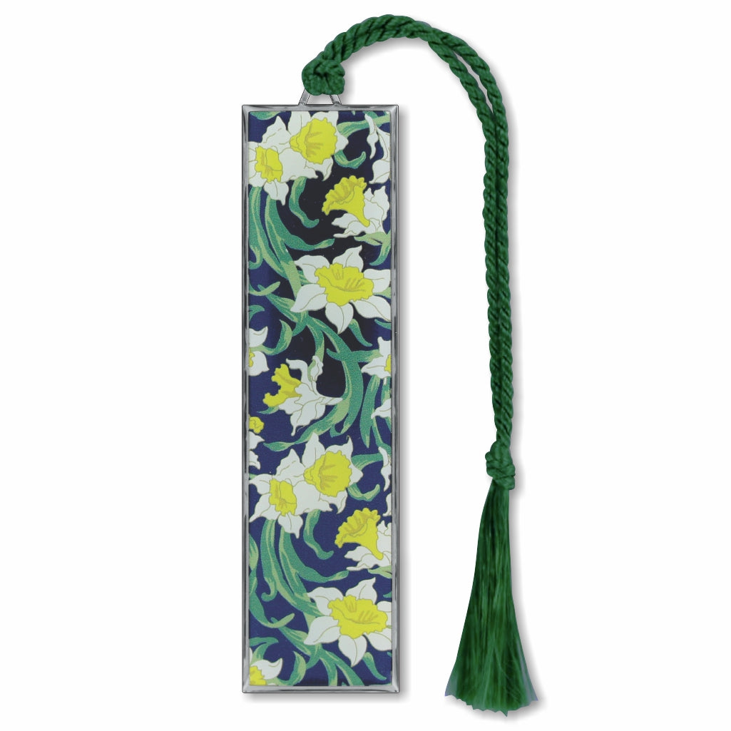 A silver metal bookmark with a floral design, featuring daffodils, with a green tassel.