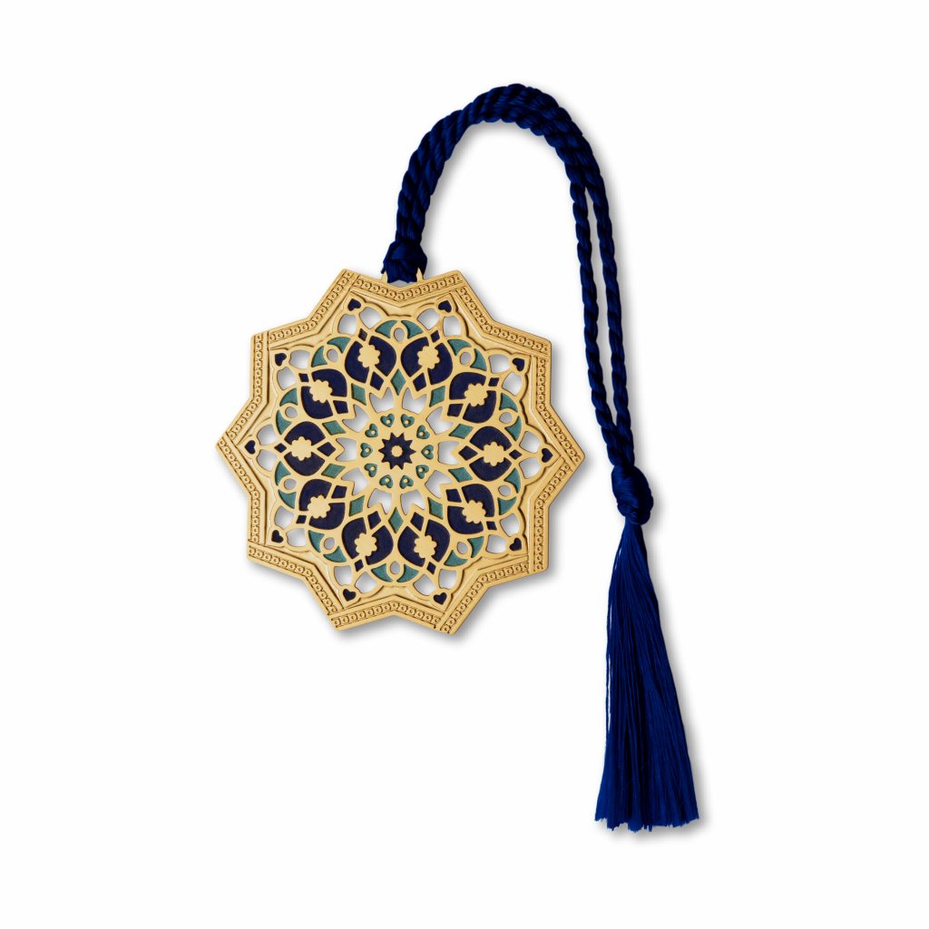 A brass metal bookmark with a geometric star pattern, finished with gold finish, attached to a blue tassel.