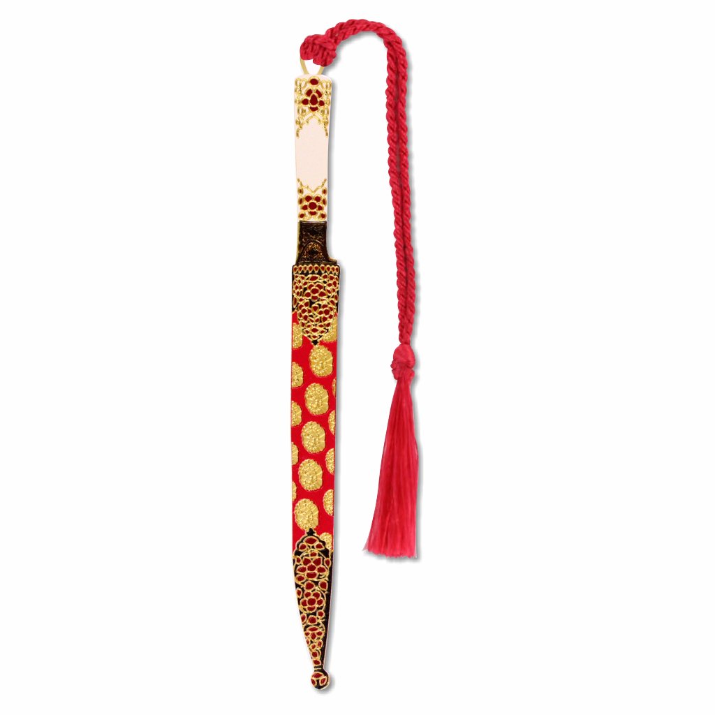 A decorative metal bookmark designed to resemble a Mughal dagger with a gold finish, floral patterns, and a red tassel.