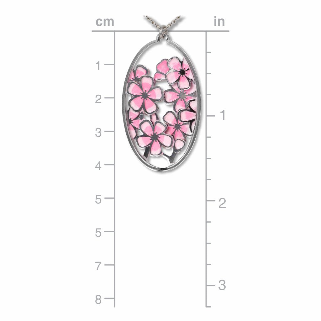 Hiroshige Cherry Blossom pendant necklace shown on a measurement chart, featuring an oval silver-tone pendant with layered pink cherry blossom flowers and openwork detailing.