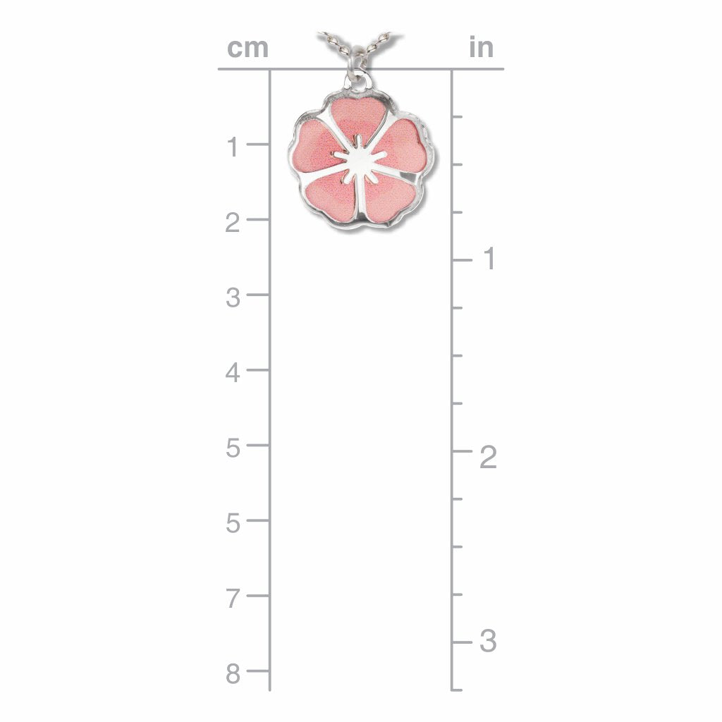 Single Blossom necklace pendant shown against a measurement guide, featuring a silver-tone cherry blossom design with soft pink petals approximately 1 inch tall.