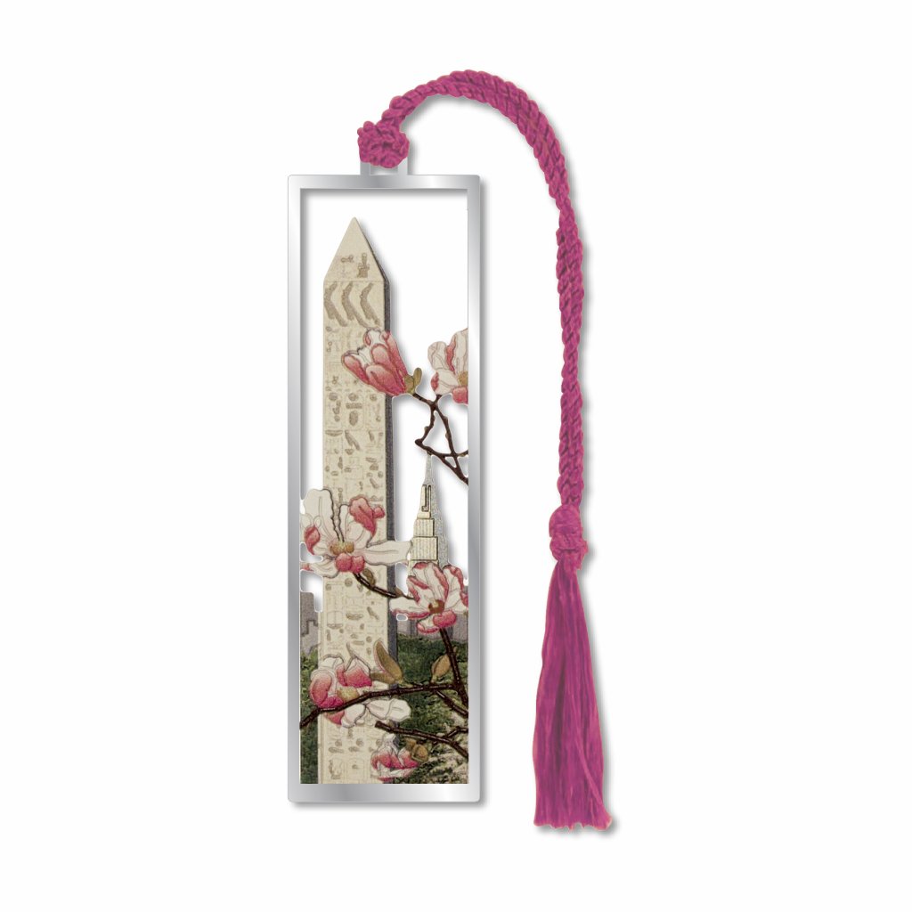 A metal bookmark of Cleopatra's Needle, an obelisk with Empire State building and cherry blossoms with a pink braided tassel.
