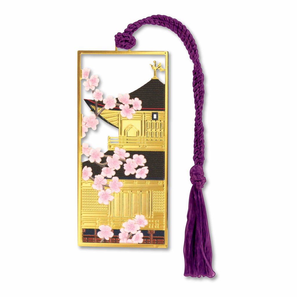 Metal bookmark inspired by Kinkaku-ji (Golden Pavilion) in Kyoto featuring the gold-leaf covered Zen temple reflected in surrounding water, with seasonal cherry blossom accents with plum tassel.
