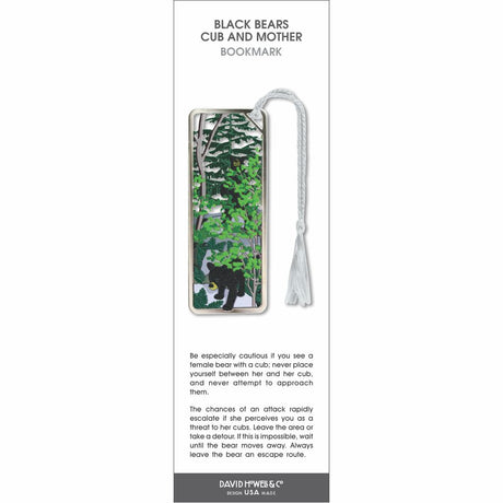 Black bears cub and mother bookmark showing a bear cub on the ground and its mother partially hidden among trees, set in a forest scene with green foliage and a white tassel.