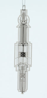 Decorative silver metal Frank Lloyd Wright Chauncey Williams Keepsake with a complex geometric design. 