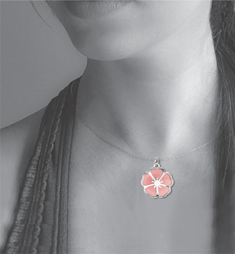 Model wearing the Single Blossom necklace, featuring a delicate silver-tone pendant with a soft pink sakura-inspired cherry blossom design.