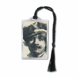 A silver metal bookmark featuring a black and white print of Rembrandt's self-portrait, with a silver finish and a black tassel.