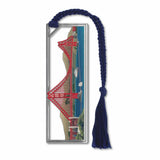 A metal bookmark with a depiction of the Golden Gate Suspension Bridge, with boats and San Francisco view in a silver frame with a blue tassel.