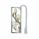 A metal bookmark with a magnolia flower design, electro-plated with non-tarnishing silver finish, attached to a silver tassel.