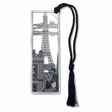 A metal bookmark featuring an image of the Eiffel Tower with two cats and a moon view, attached to a black braided tassel.