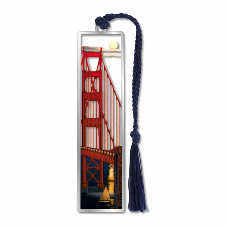 A metal bookmark of Moonlight on the suspension bridge’ bookmark featuring the Golden Gate Bridge at night with a sailboat and blue tassel.