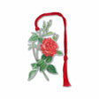 A silver  brass metal bookmark with a floral design, featuring a red rose and green leaves  with a red braided tassel.